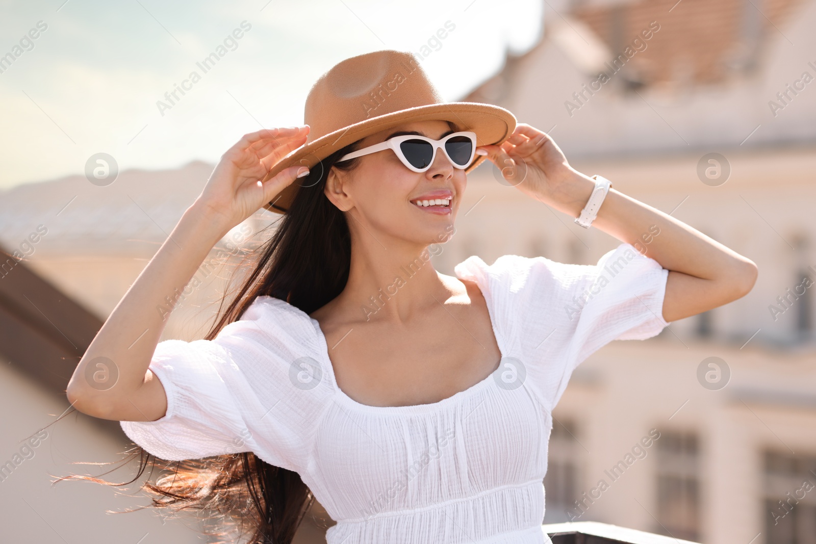 Photo of Smiling woman in stylish hat and sunglasses outdoors