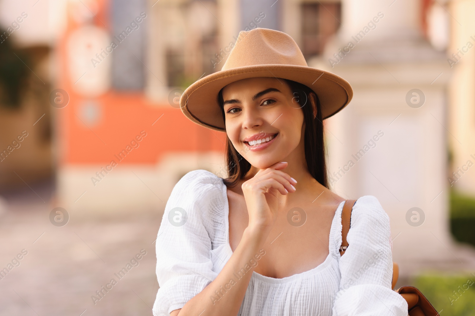 Photo of Beautiful young woman in stylish hat outdoors