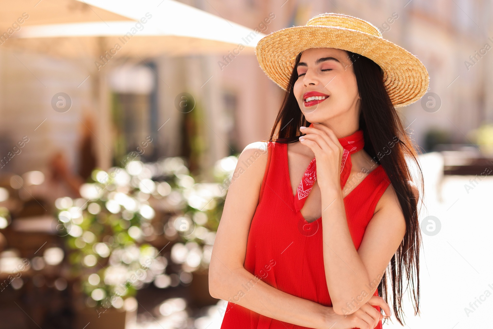 Photo of Beautiful young woman in stylish hat on city street. Space for text