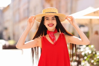 Photo of Beautiful young woman in stylish hat on city street