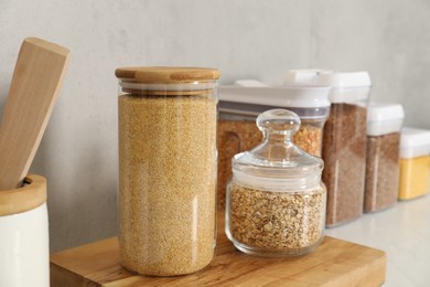 Photo of Different types of cereals in containers on light table