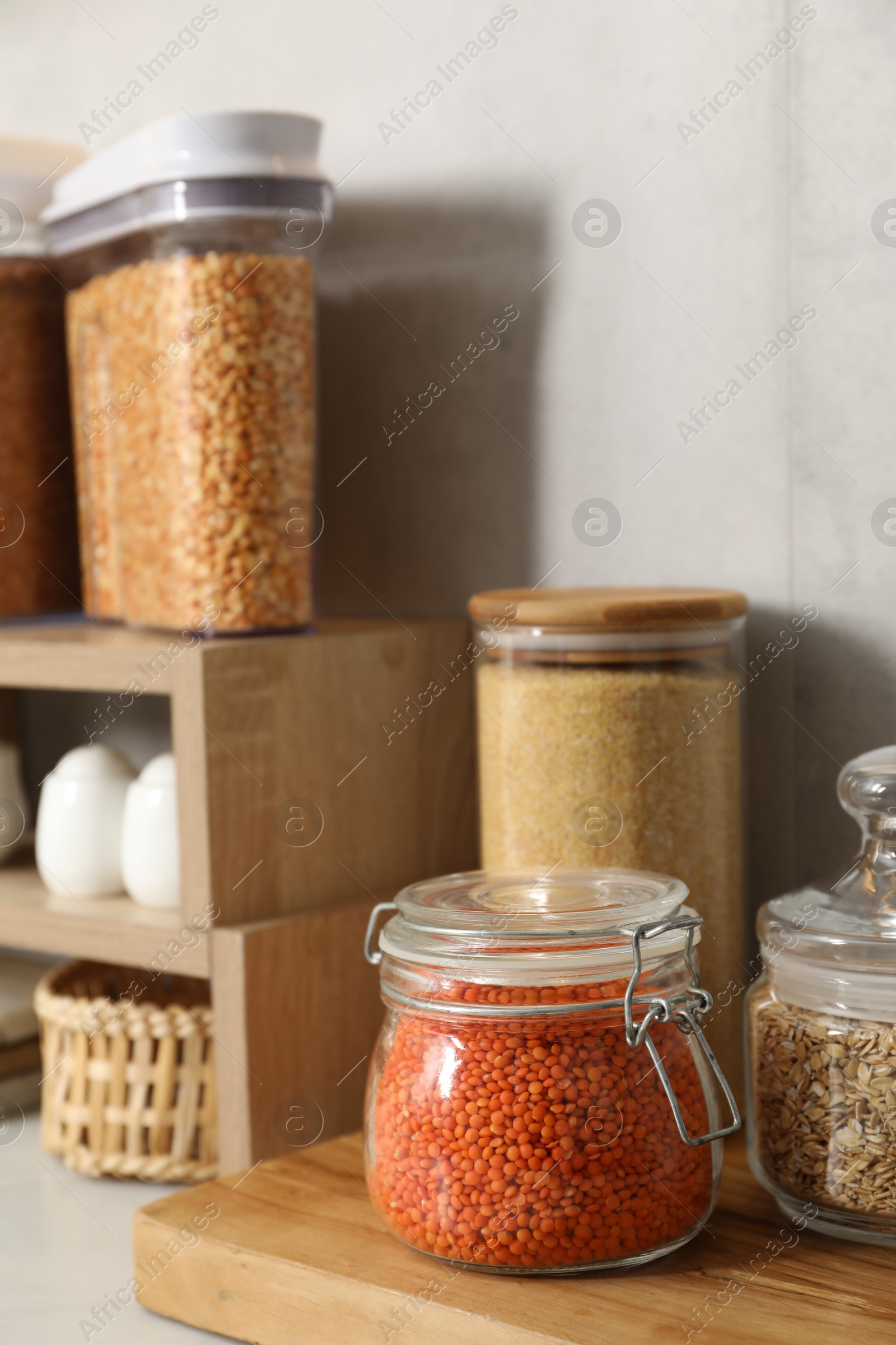 Photo of Different types of cereals and legumes in containers on table