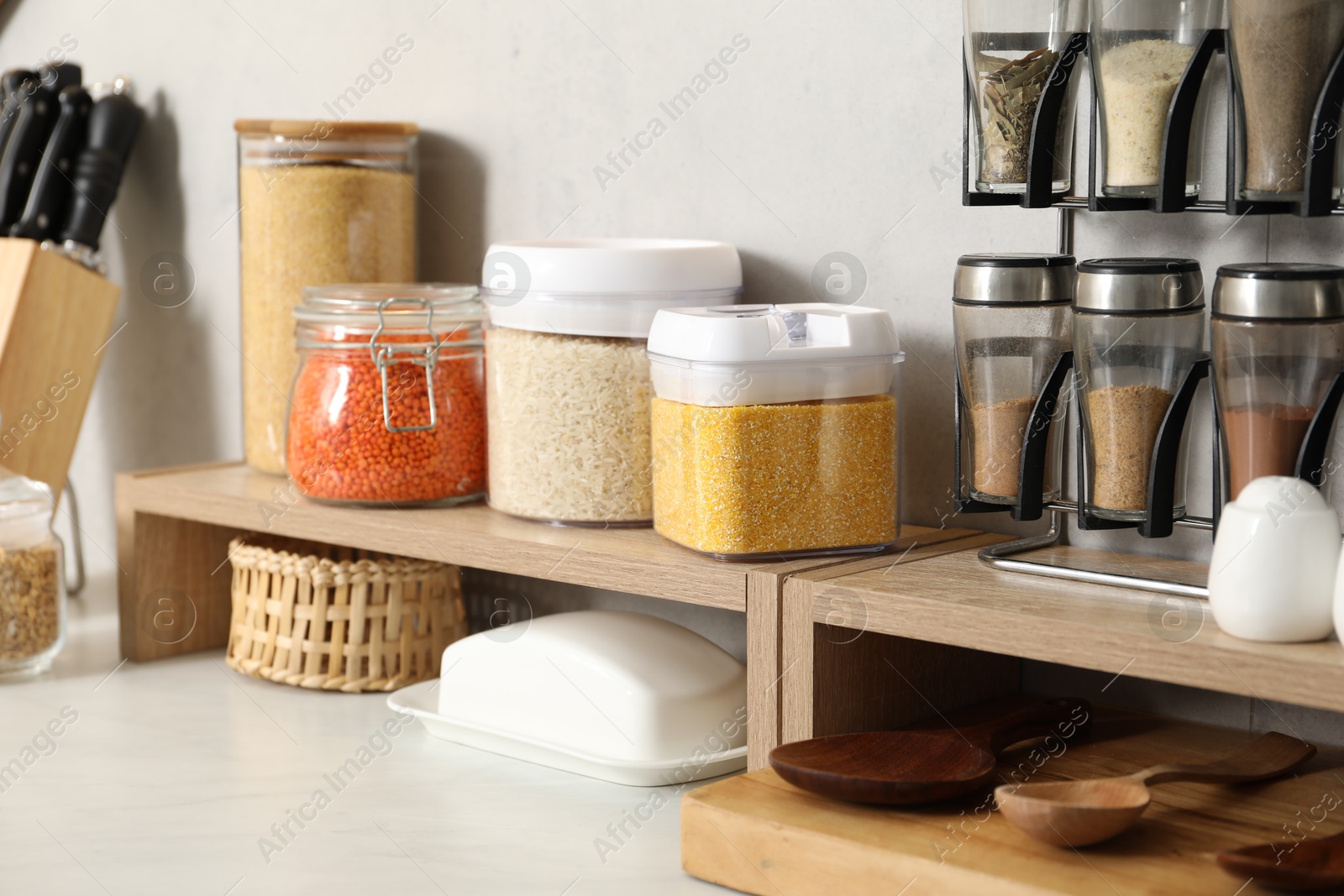 Photo of Different types of cereals and legumes in containers on light marble table