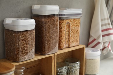 Different types of cereals and legumes in containers on light table