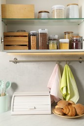 Photo of Different types of cereals and legumes in containers in kitchen