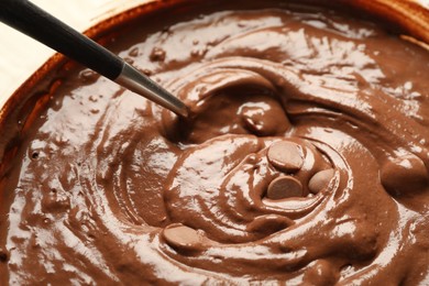 Photo of Melting chocolate chips for dough in bowl, closeup