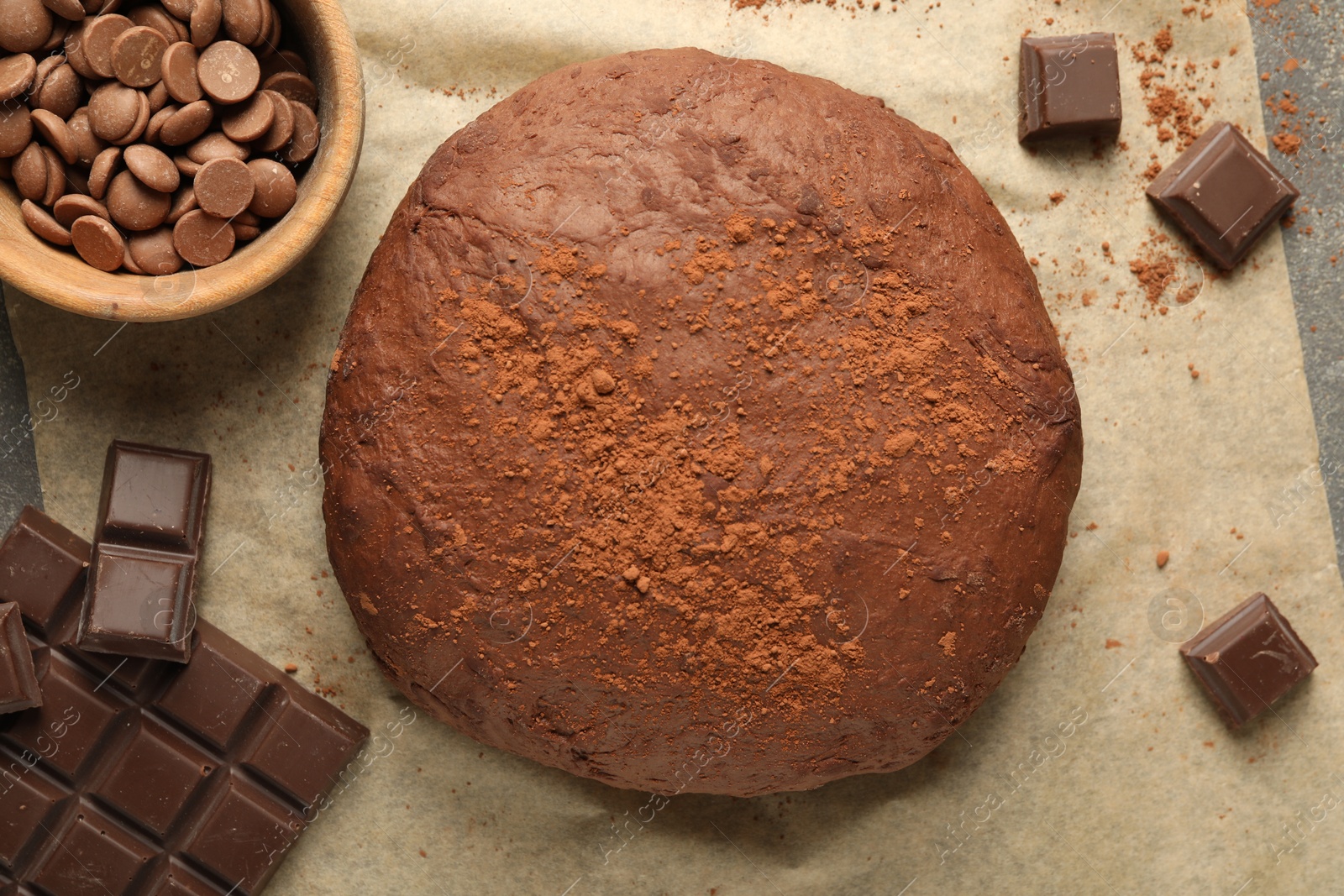 Photo of Chocolate dough and ingredients on table, flat lay