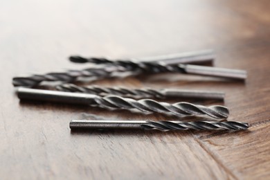 Photo of Many different drill bits on wooden surface