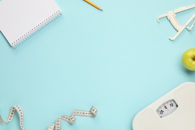 Photo of Flat lay composition with body fat caliper and measuring tape on light blue background. Space for text