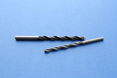 Photo of Two drill bits on light blue background