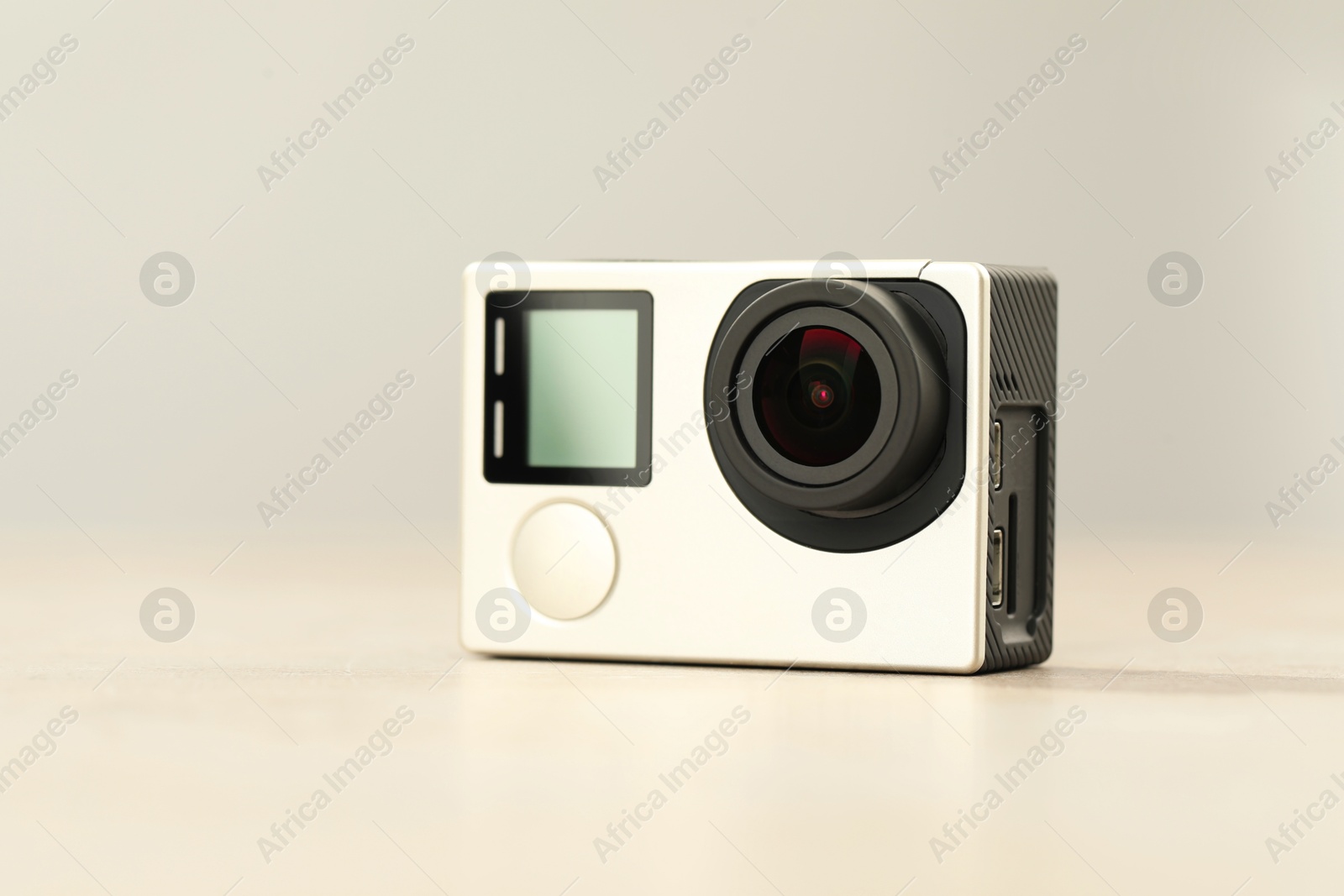 Photo of Modern action camera on light grey background, closeup