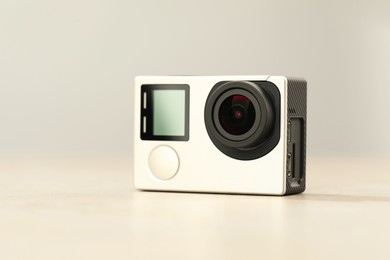 Photo of Modern action camera on light grey background, closeup