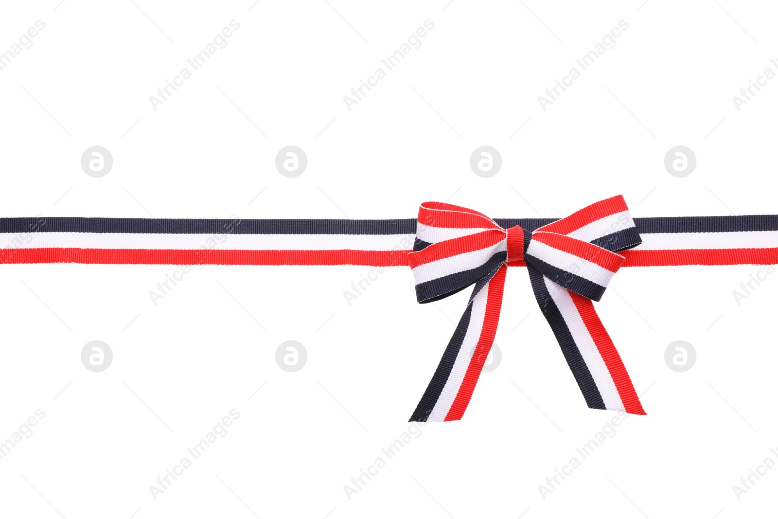 Photo of Ribbon with bow in colors of Yemeni flag isolated on white, top view