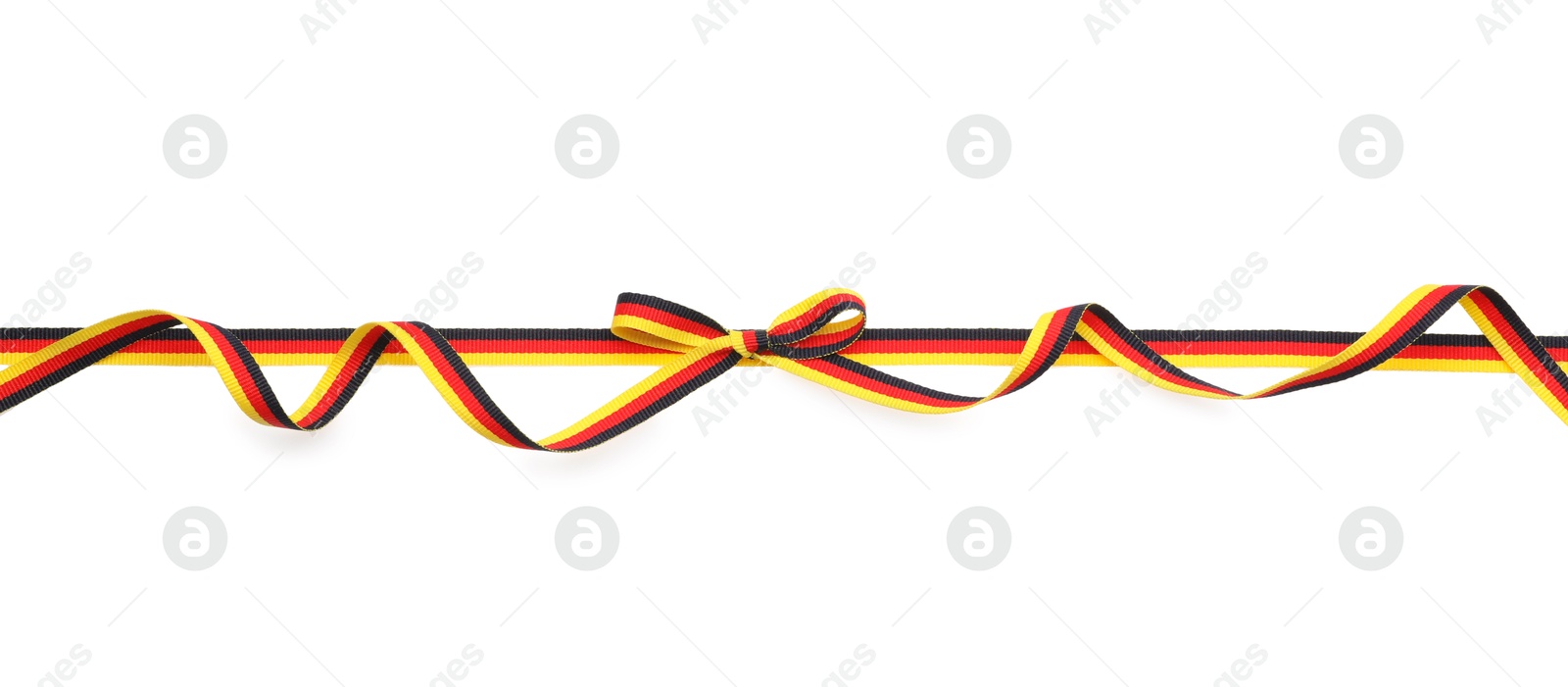 Photo of Ribbon with bow in colors of German flag isolated on white, top view