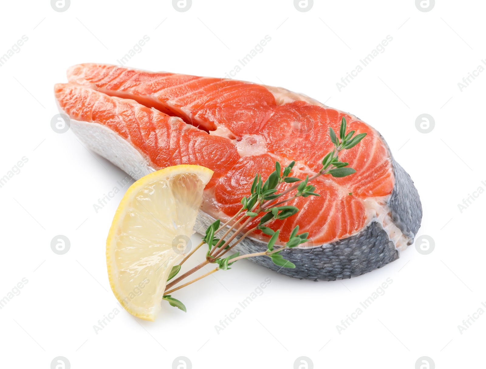 Photo of Fresh salmon steak, lemon and thyme isolated on white