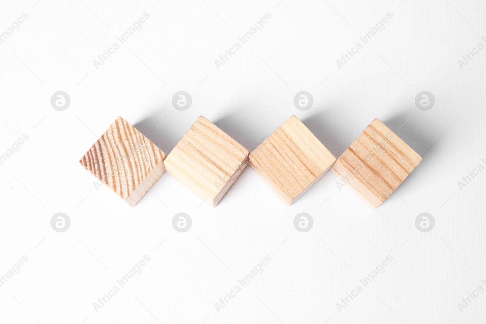 Photo of Many blank wooden cubes on white background, above view