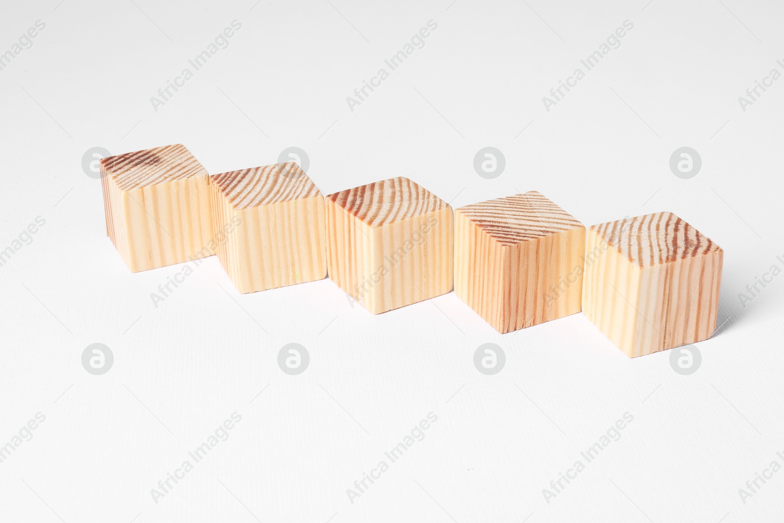 Photo of Many blank wooden cubes on white background