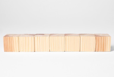 Photo of Many blank wooden cubes on white background