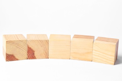 Photo of Many blank wooden cubes on white background