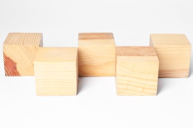 Photo of Many blank wooden cubes on white background