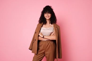 Photo of Beautiful young woman in stylish suit on pink background