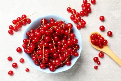 Fresh red currants on light grey table, flat lay