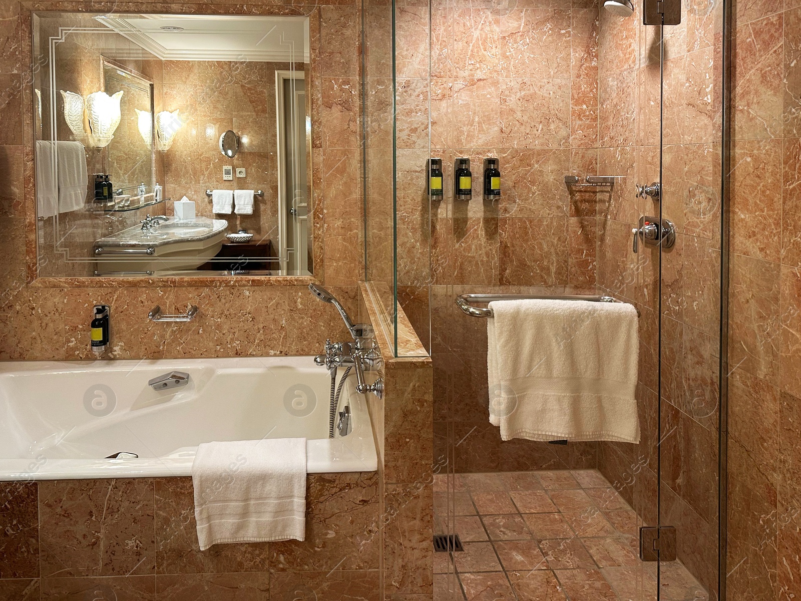 Photo of Luxury hotel interior. Stylish bathroom with modern tub and mirror