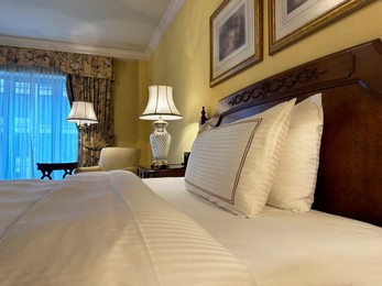 Photo of Comfortable large bed with luxury bedding in hotel room