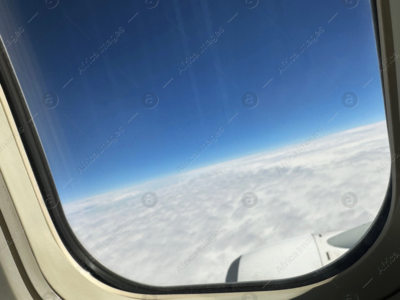 Photo of Beautiful blue sky with fluffy clouds, view from plane window