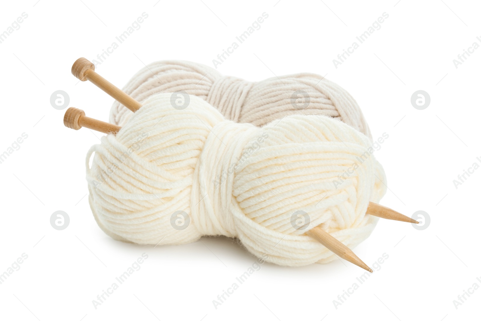 Photo of Skeins of soft yarn and knitting needles isolated on white