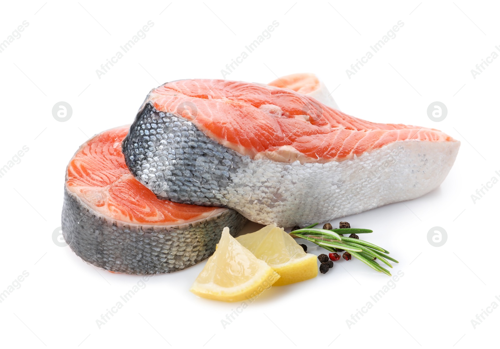 Photo of Two fresh salmon steaks, lemon, rosemary and peppercorns isolated on white