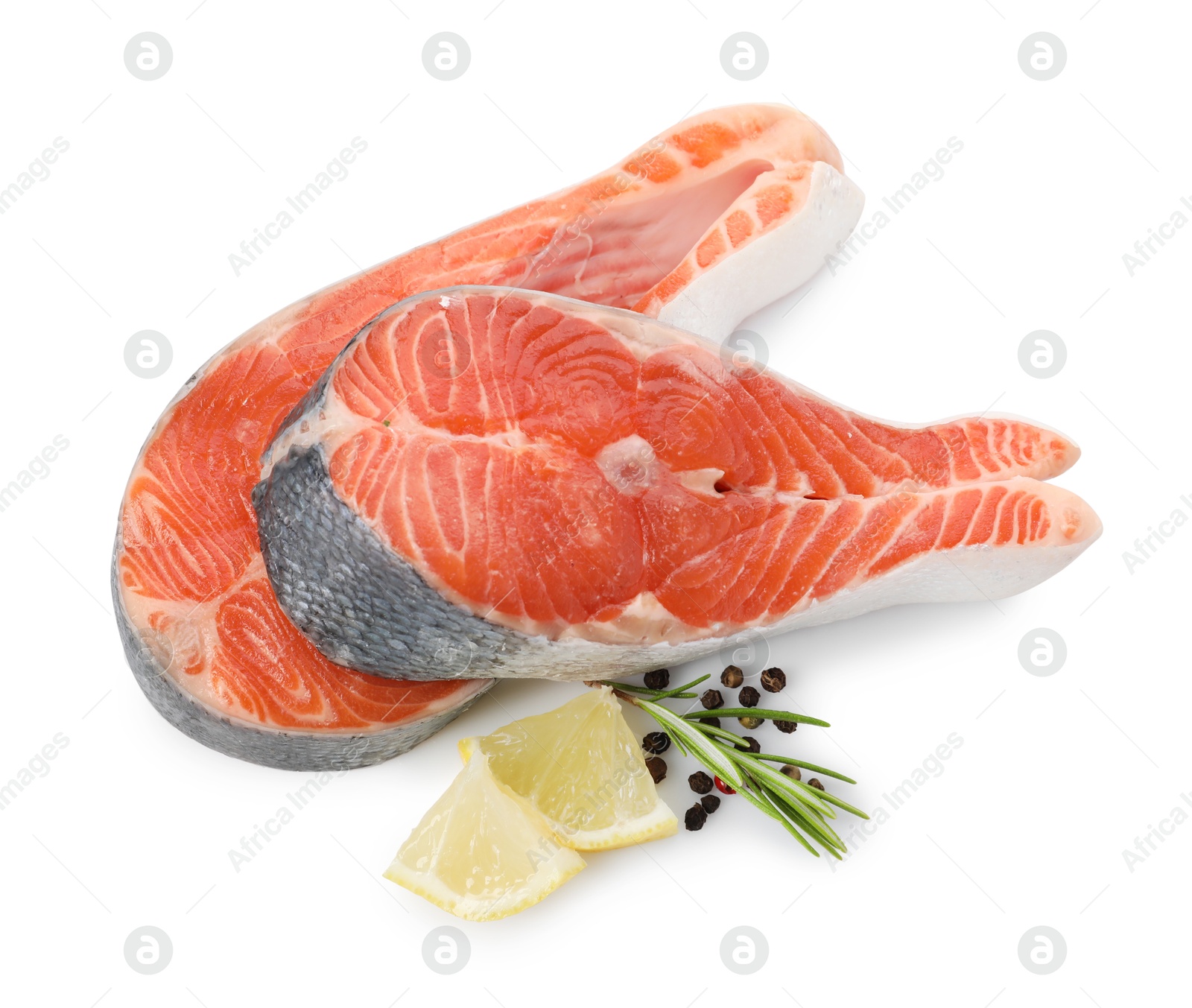 Photo of Two fresh salmon steaks, lemon, rosemary and peppercorns isolated on white, above view