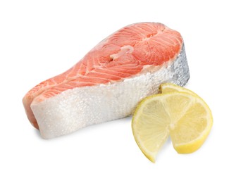 Fresh salmon steak and piece of lemon isolated on white