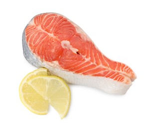 Photo of Fresh salmon steak and piece of lemon isolated on white, above view