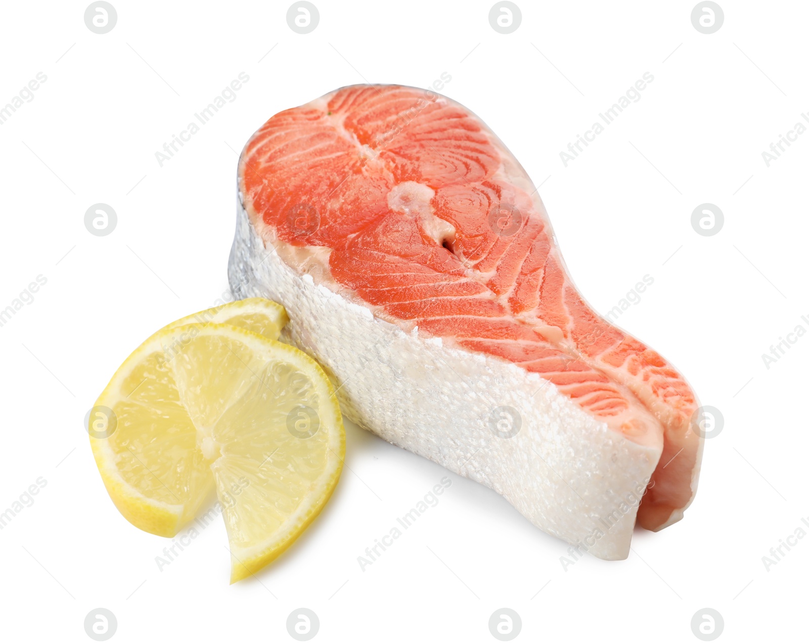 Photo of Fresh salmon steak and piece of lemon isolated on white