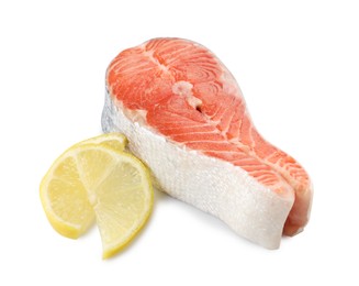 Fresh salmon steak and piece of lemon isolated on white