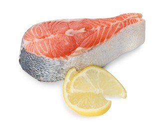 Photo of Fresh salmon steak and piece of lemon isolated on white