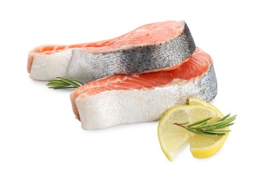 Photo of Two fresh salmon steaks, lemon and rosemary isolated on white