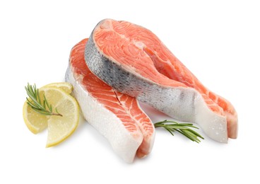 Photo of Two fresh salmon steaks, lemon and rosemary isolated on white