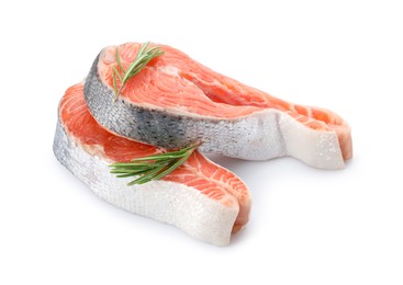 Two fresh salmon steaks and rosemary isolated on white