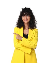 Beautiful young woman in stylish yellow suit pointing at something on white background