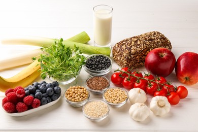 Different fresh products on white wooden table. Source of prebiotics