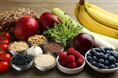 Photo of Different fresh products on wooden table. Source of prebiotics