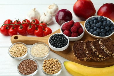 Photo of Different fresh products on white wooden table. Source of prebiotics