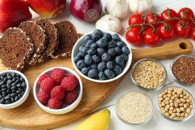 Photo of Different fresh products on white wooden table. Source of prebiotics