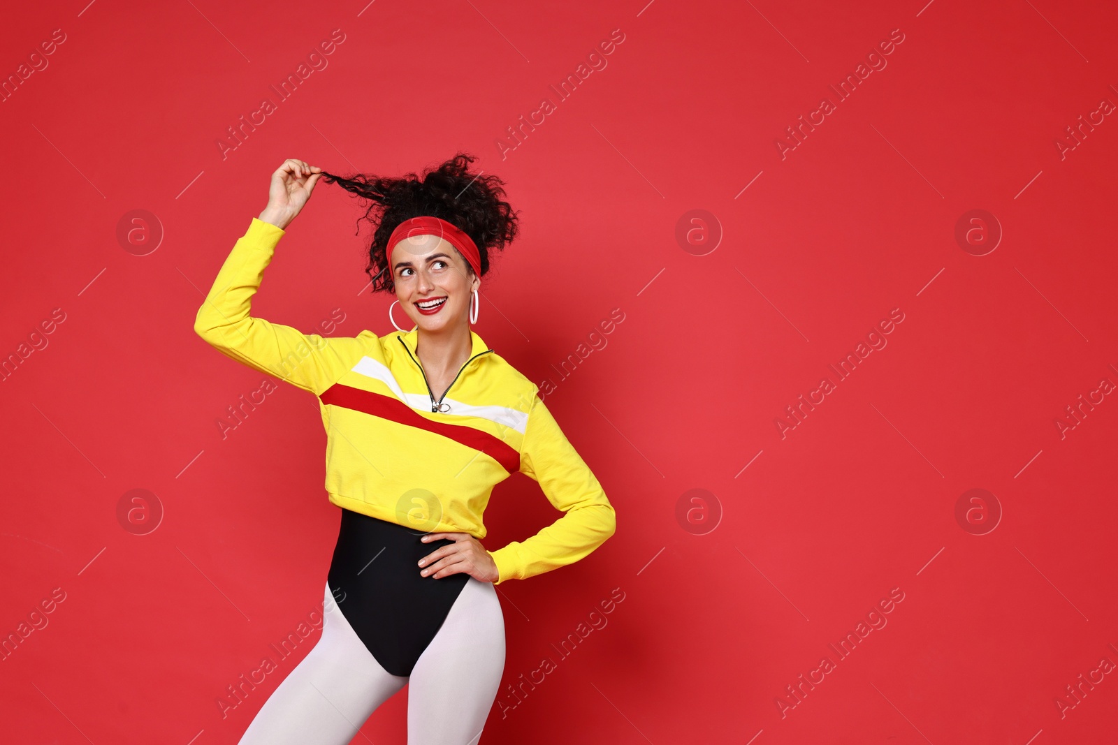 Photo of Aerobics. Happy woman in sportswear on red background, space for text