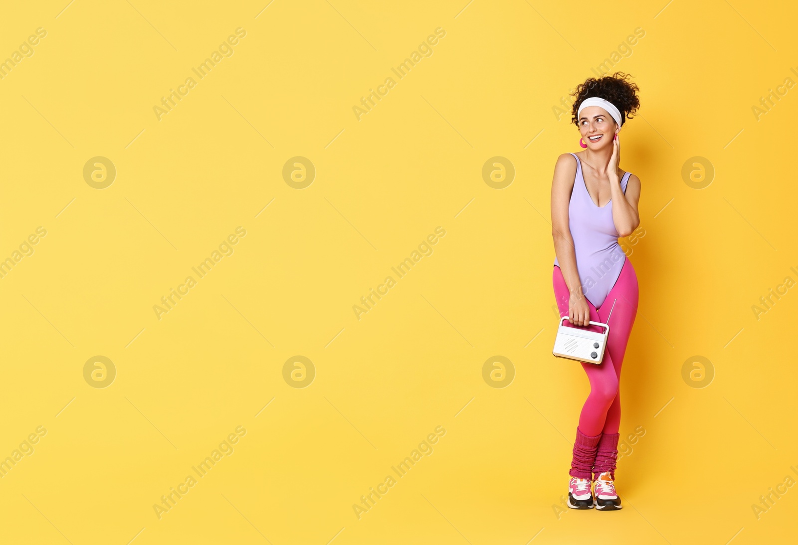 Photo of Aerobics. Woman with radio receiver on orange background, space for text