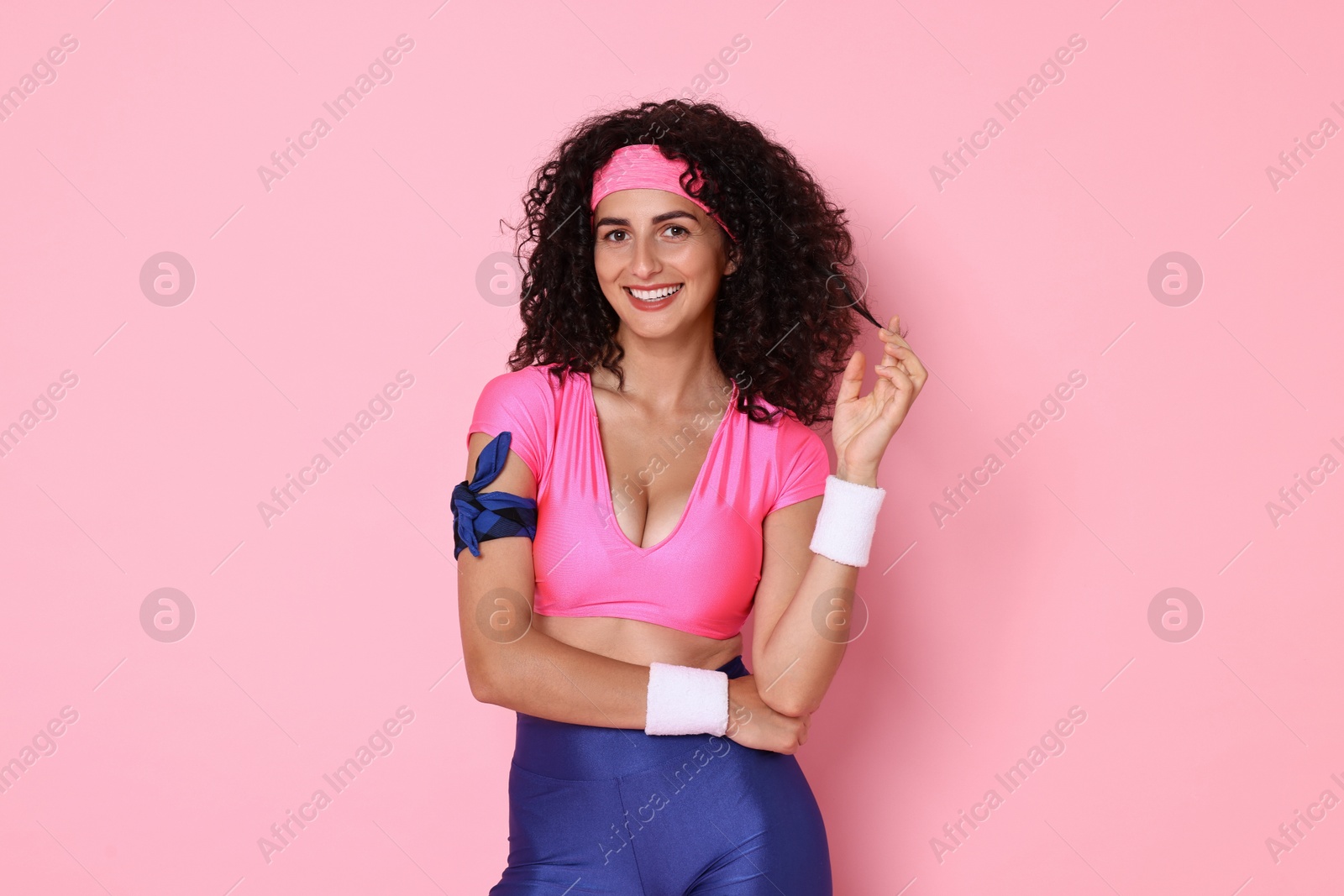 Photo of Aerobics. Happy woman in sportswear on pink background