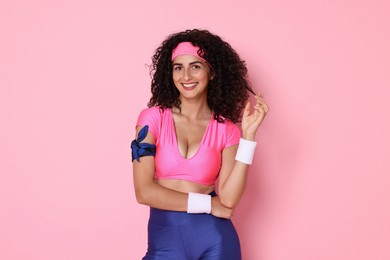 Aerobics. Happy woman in sportswear on pink background