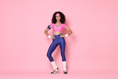 Photo of Aerobics. Happy woman in sportswear on pink background